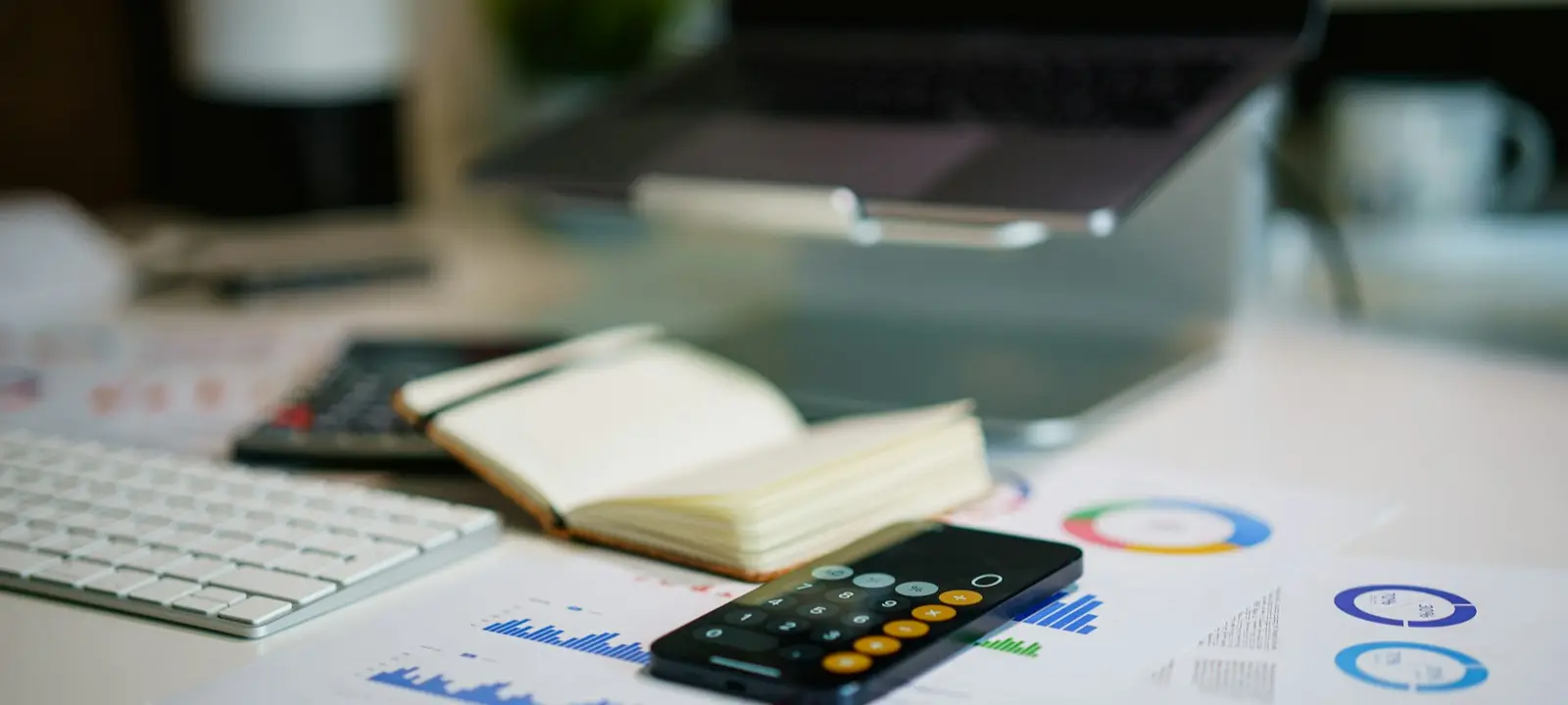 Calculator and financial charts on a desk