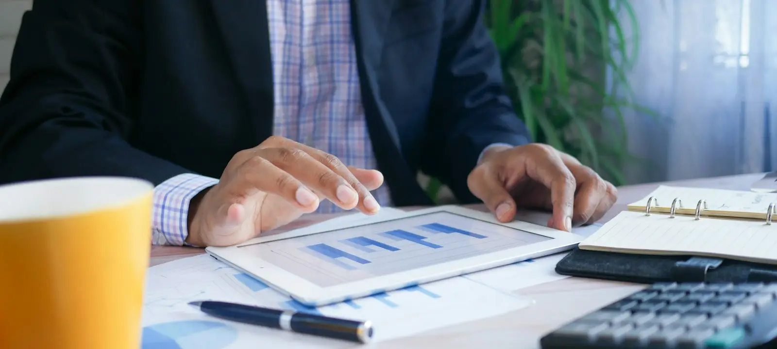 Board member reviewing financial reports on a tablet