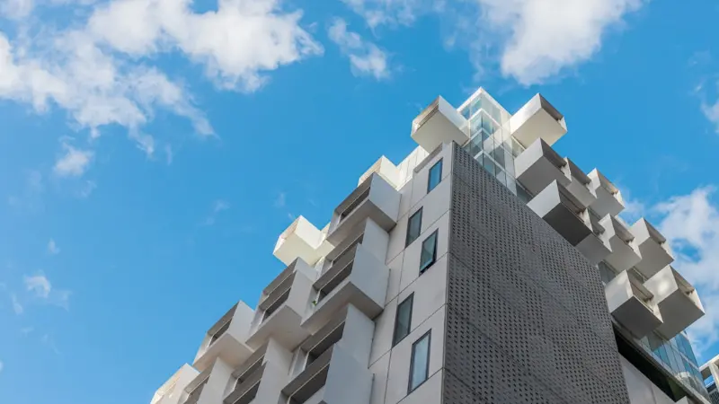 Condo building against a blue sky